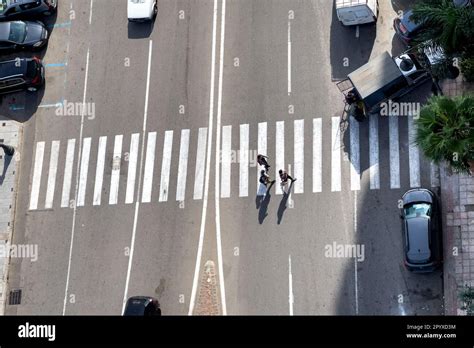 An aerial view of Pedestrians crossing the zebra lines Stock Photo - Alamy