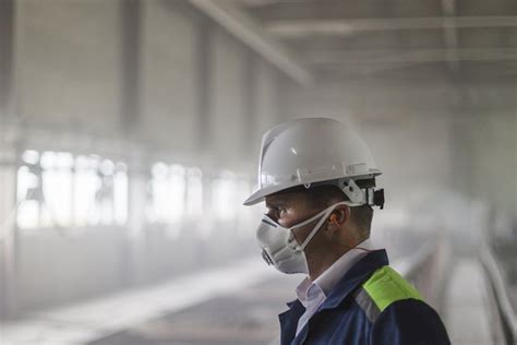 Mining engineer in white helmet and respirator (584008)