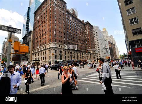 Pedestrians crossing the 6th Avenue on the corner of West 55th street in Manhattan, New York ...