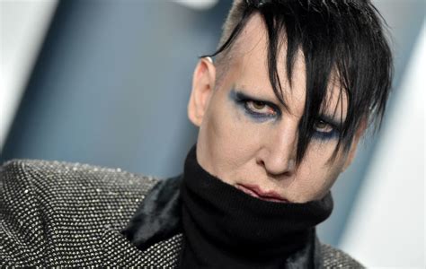 Marilyn Manson turns himself into police for alleged spitting incident ...