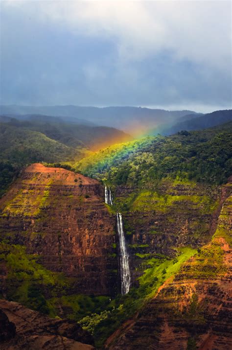 Yesterday a rainbow appeared over a hanging waterfall for about minutes in Waimea Canyon Kauai ...