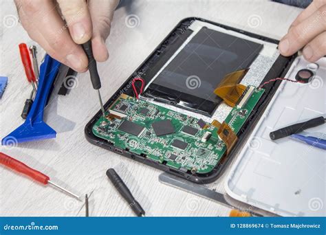 Repairing the Tablet on the Website. Opening the Tablet by an Employee Stock Photo - Image of ...