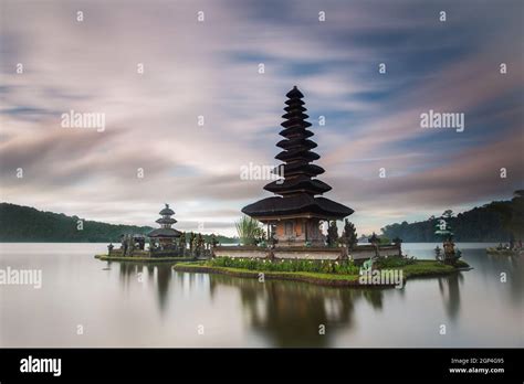 INDONESIA, BALI. SUNRISE OVER THE ULUN DANU TEMPLE ON THE BRATAN LAKE ...