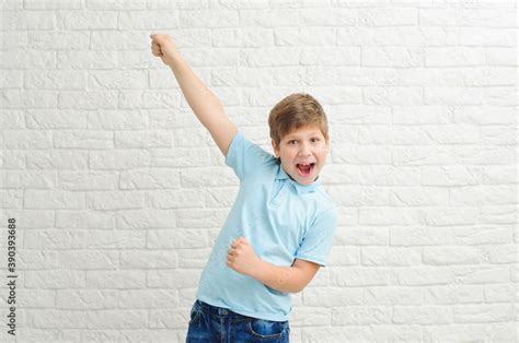 Happy boy making dab arms gesture on white studio background, funny guy dabbing moving in ...