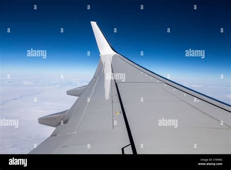 Airplane Boeing-737 wing as seen from a plane window with a bright blue sky Stock Photo - Alamy