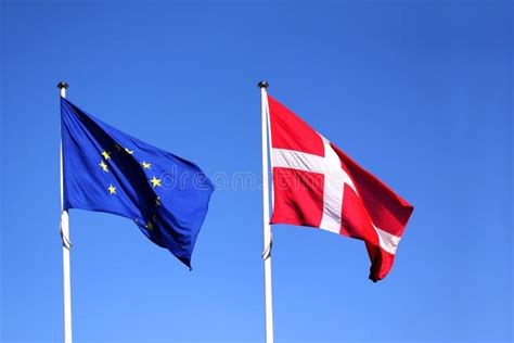 European Union EU and Danish Flag for Denmark on a Pole Waving in the ...