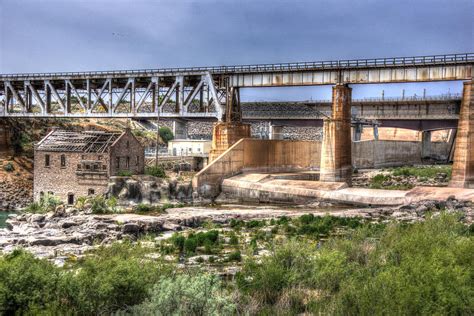 American Falls Idaho Dam And Old Power House 1 by Kevin Oliverson