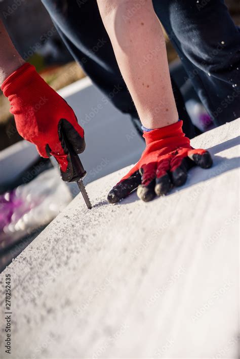 Cutting styrofoam on the construction site Stock Photo | Adobe Stock