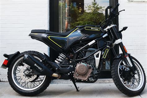 a black and yellow motorcycle parked in front of a building