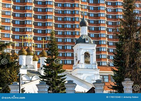 Old White Church on the Background of a Modern Building. a Combination of History and Modernity ...