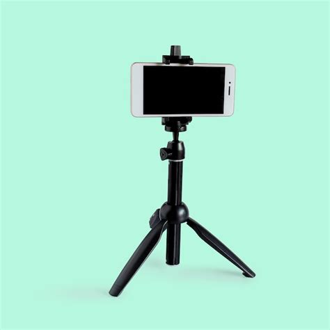 Premium Photo | Mini tripod for Mobile phone on white background.