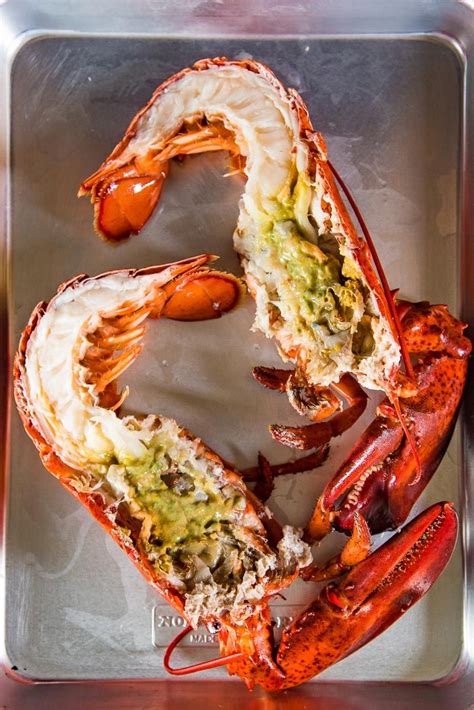 A whole lobster cut in half, showing the green tomalley. | How to cook ...