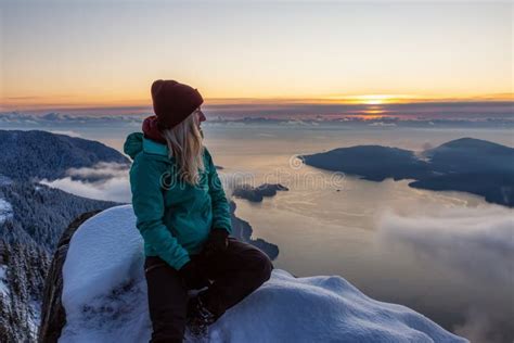 Adventurous Blond Caucasian Girl Sitting on Top of a Snow Covered Mountain Stock Photo - Image ...