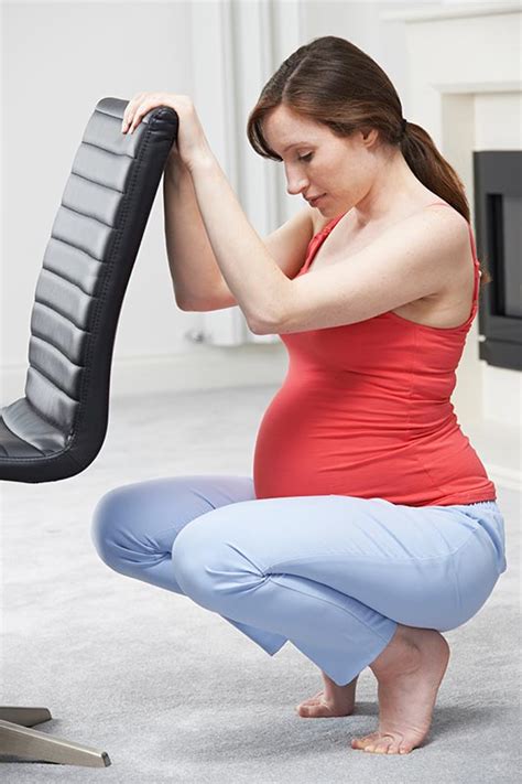 A pregnant woman performing squats