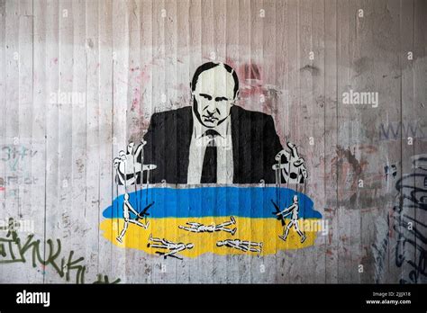 Mural graffiti or stencil graffiti of Putin as a puppet master ...