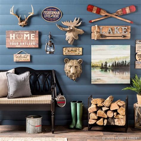 a living room filled with furniture and lots of wall art hanging on the ...