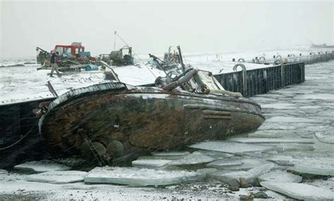 A fishing boat that sunk in a boat harbor is shown in Nome, Alaska.... Photo-photo.31992 ...