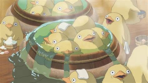 a bunch of birds that are standing in front of some buckets filled with ...