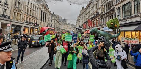 Campaigners march through London in protest against climate change ...