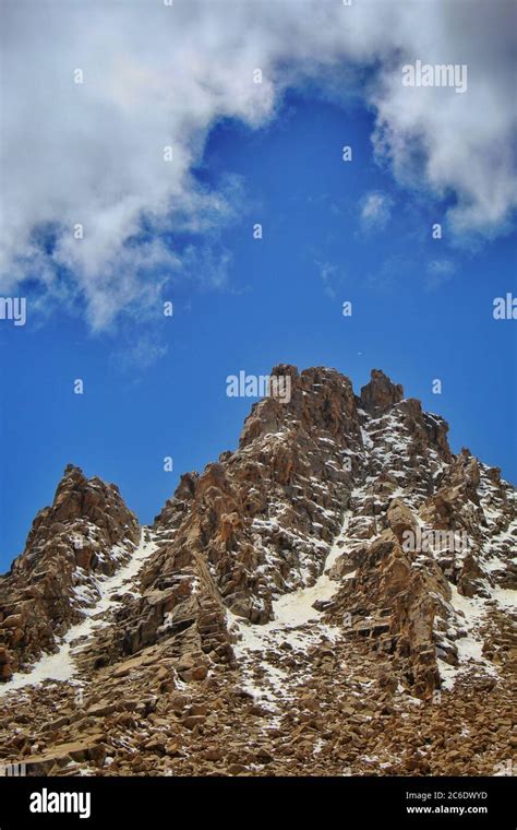 scenic view of a mountains in ladakh with a blue sky and clouds above ...