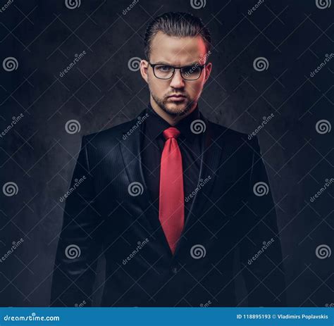 Portrait Of A Stylish Male In A Black Suit And Red Tie. Isolated On A Dark Background. Stock ...