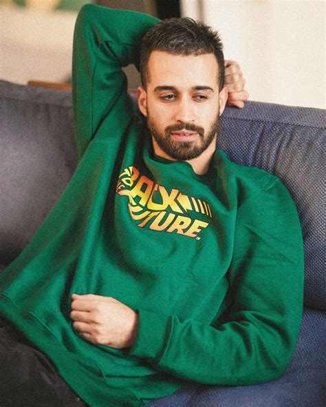Man in green and yellow sweater sitting on black couch photo – Free Photo Image on Unsplash