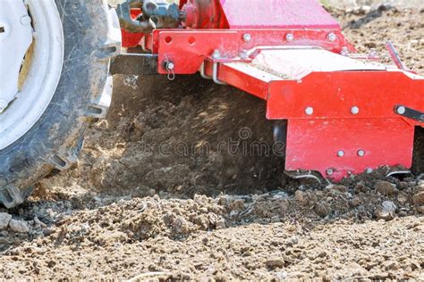 Farmer Plows the Field. Small Tractor with a Plow in the Field ...