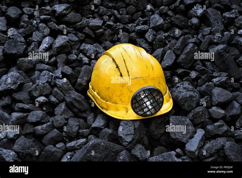 Yellow miners safety helmet on top of the coal mining Stock Photo - Alamy