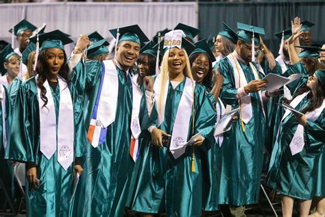 Graduates pose for the camera as they show off their success at Tri-C ...