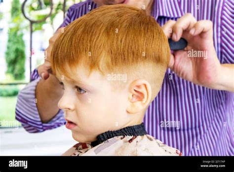 haircut of a little red-haired boy. beauty salon. kid's barbershop Stock Photo - Alamy