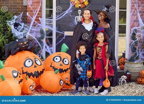 Portrait of Family Dressed Up for Halloween Outside House Ready for ...