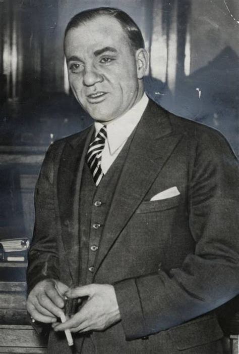 an old black and white photo of a man in a suit