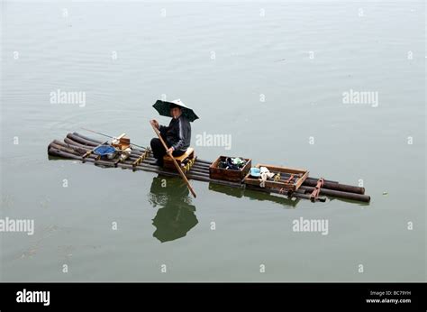 Fisherman on bamboo raft Li River Guilin Guangxi China Stock Photo - Alamy