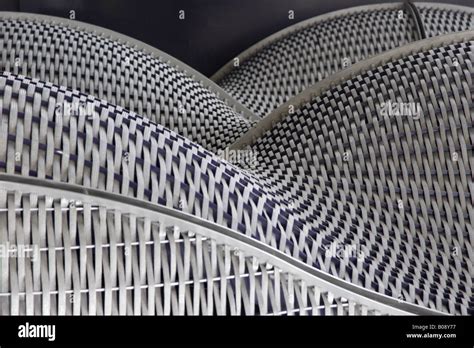 Patterns made by the steel weave of an architectural facade Stock Photo - Alamy