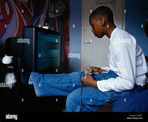 Boy playing a video game Stock Photo - Alamy