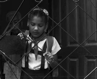 Cuban school girl behind gate. | Carlyle Ellis Photography/Human Quotient | Flickr