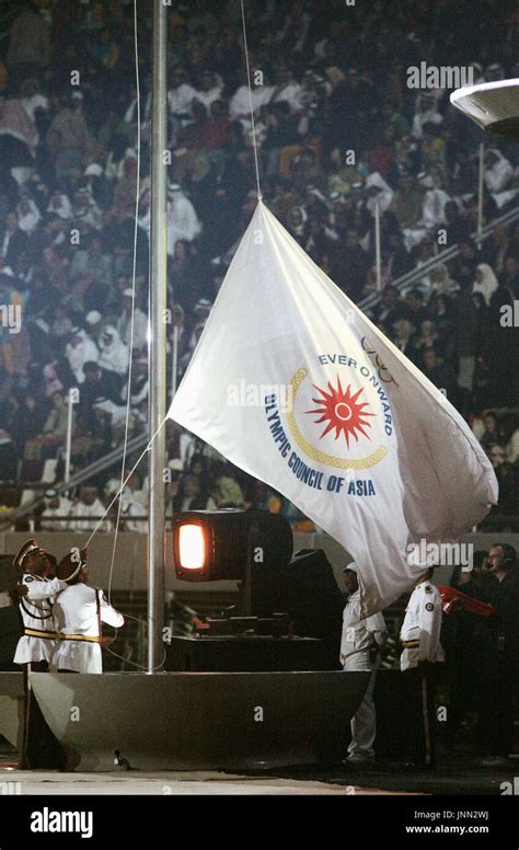 DOHA, Qatar - The flag for the Asian Games is lowered at Khalifa ...