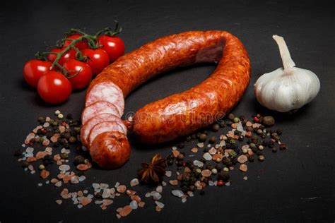 Sliced Circle of Dry Cured Sausage with Garlic and Tomatoes Cherry Stock Photo - Image of chunk ...