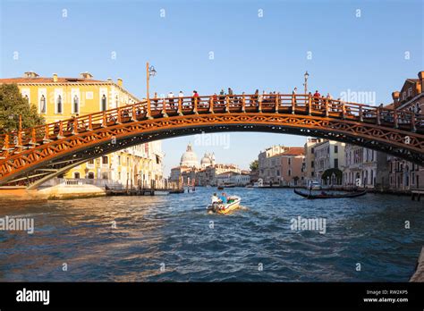 Tourists on the Accademia Bridge over the Grand Canal at sunset ...