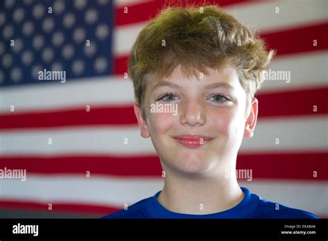 Ten year old american boy standing in front of an american flag in ...