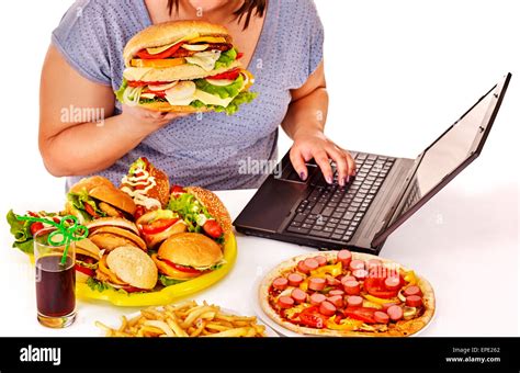 Woman eating junk food Stock Photo - Alamy