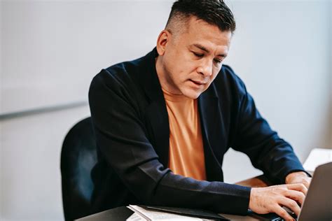 Photo Of Man Smiling In Front Of His Laptop · Free Stock Photo