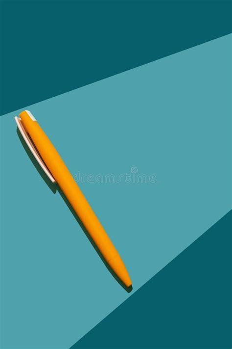 Yellow Ballpoint Pen on a Blue Background. Stock Image - Image of ...