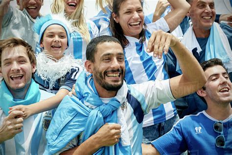 Argentinian football fans watching football match - Stock Photo - Dissolve