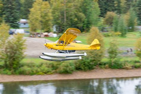 Bush Float Plane Flying Over River in Alaska Stock Photo - Image of ...