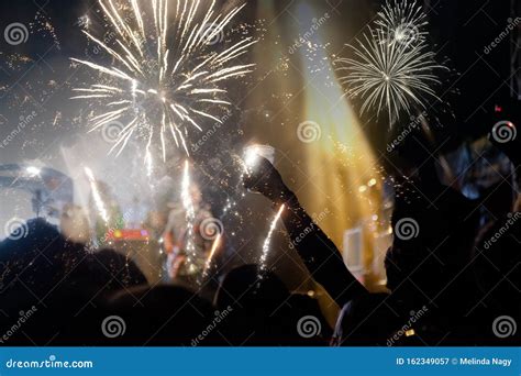 New Year Concept - Cheering Crowd and Fireworks Stock Image - Image of ...