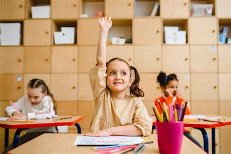 Girl Raising Hand Inside the Classroom · Free Stock Photo