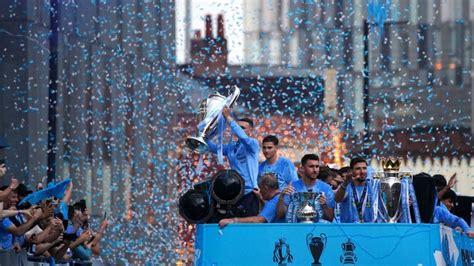 Manchester City fans and players celebrate historic Treble in the rain ...