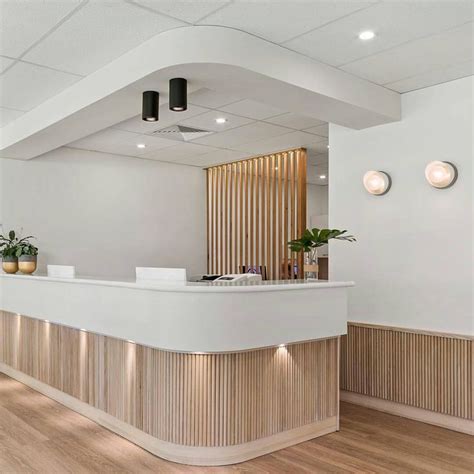 We love the use of Tas Oak dowel in this stunning eye clinic reception. Interior … | Hospital ...