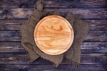 Premium Photo | Round tray for pizza on dark wooden table.